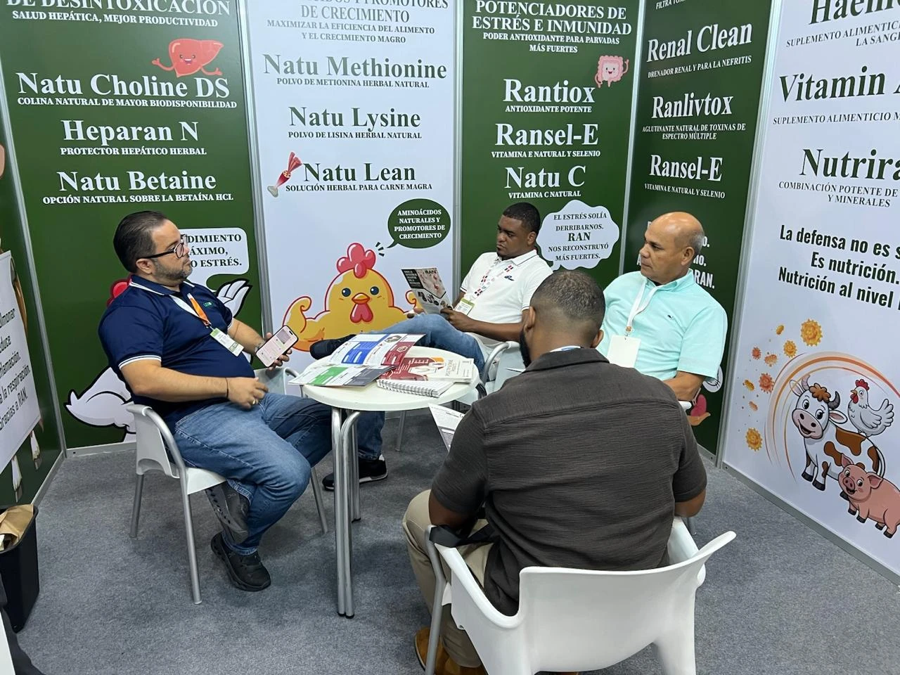 Customers talk, seated at the RAN booth